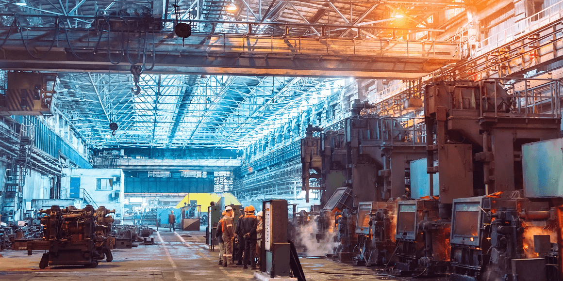 workers on the floor of a steel manufacturing plant